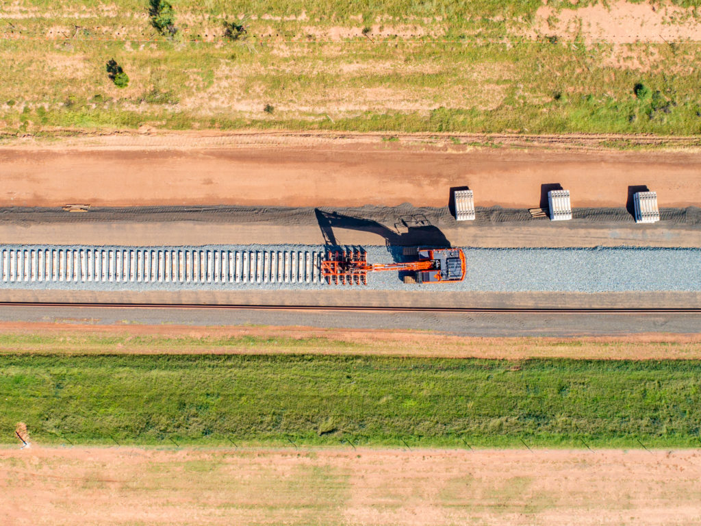 Machine lays concrete sleepers on a rail line