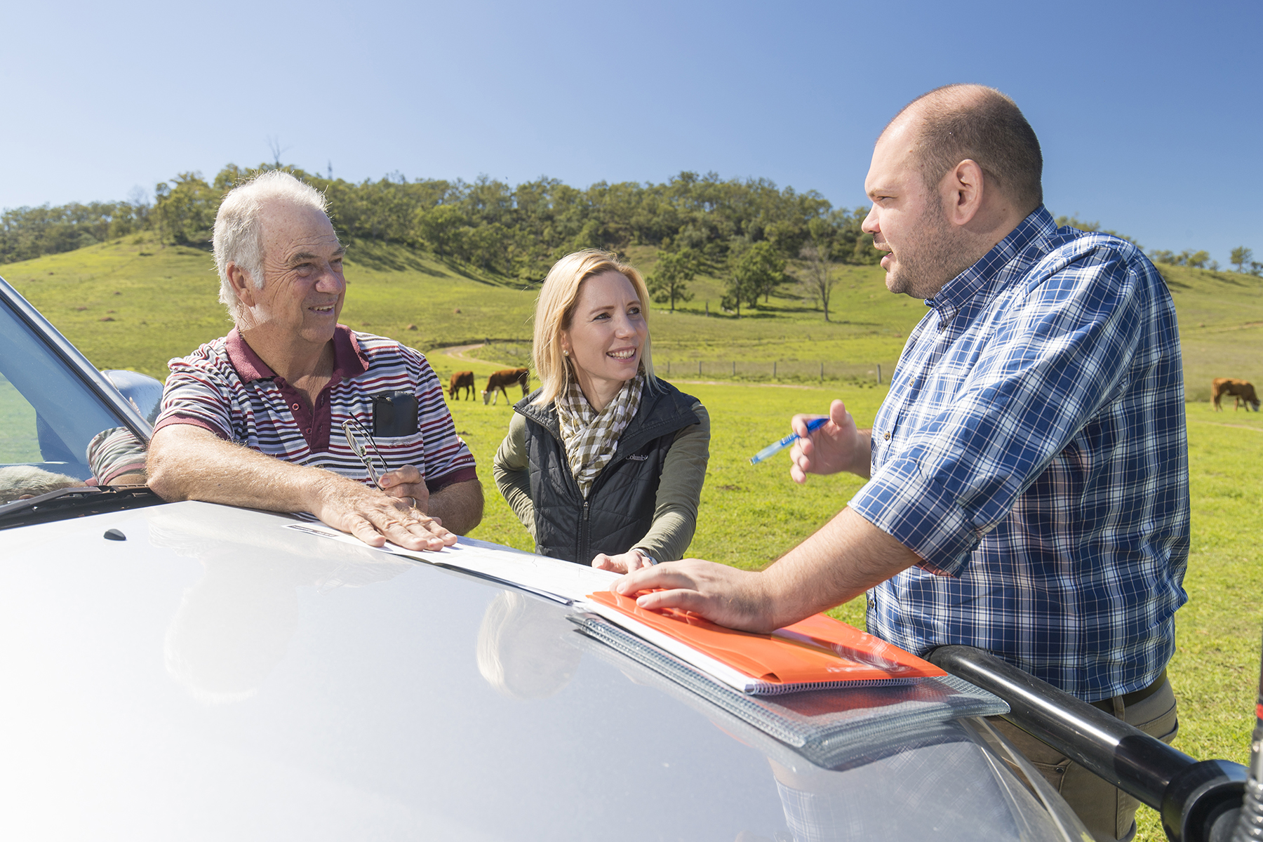 Inland Rail representatives standing talking with a landowner on his rural property
