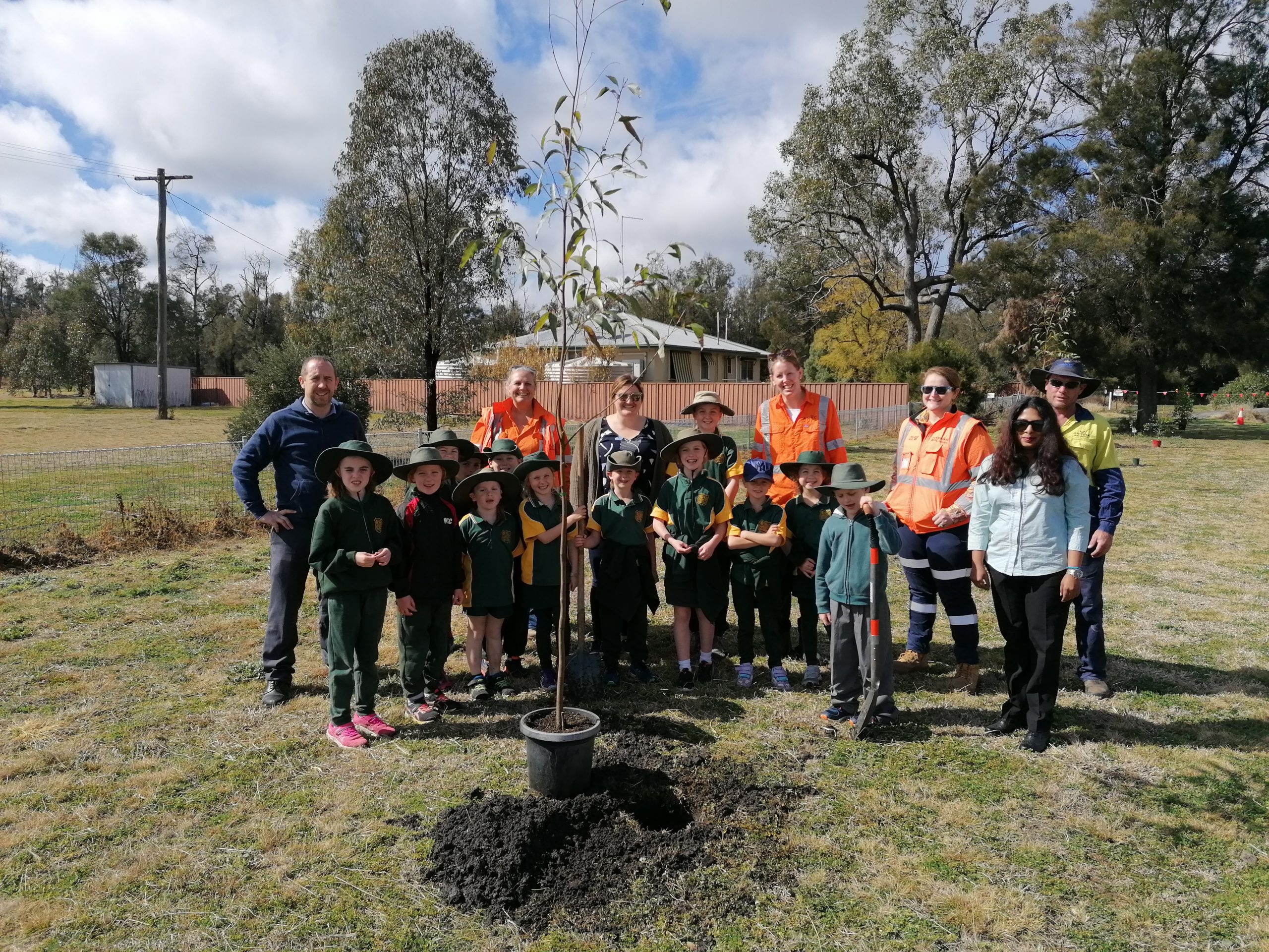 Team members from Inland Rail and Gwydir Shire Council, and staff and students from Croppa Creek School prepare to plant trees.