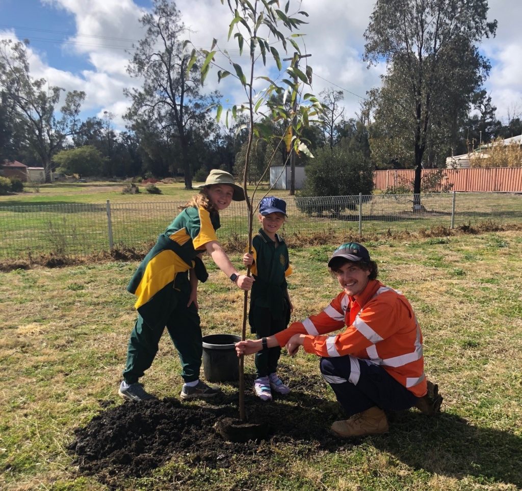 Trans4m Rail team member and Croppa Creek School student plant trees.