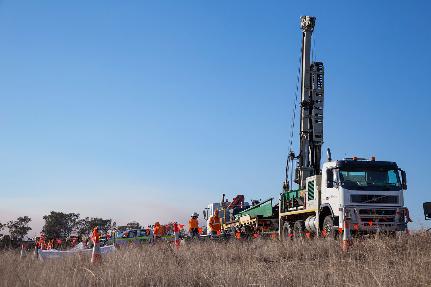 Image of a truck carrying machinery at an investigation site.