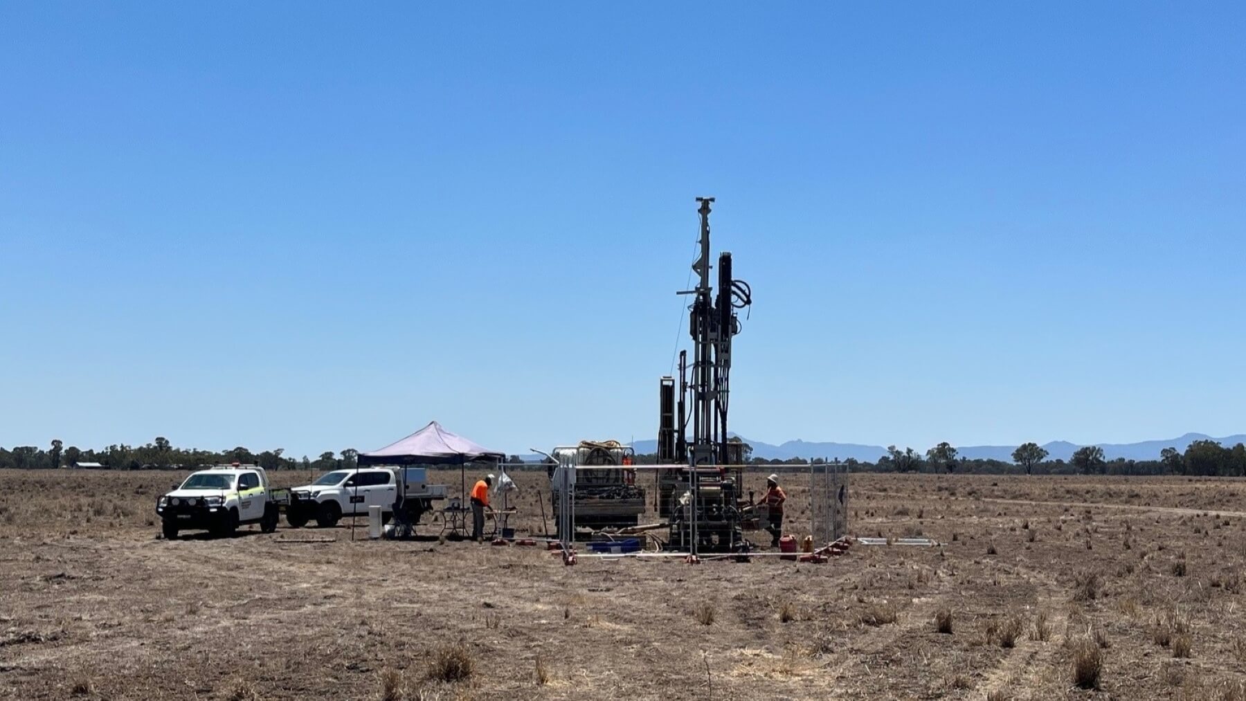 A drill rig operating in a field.