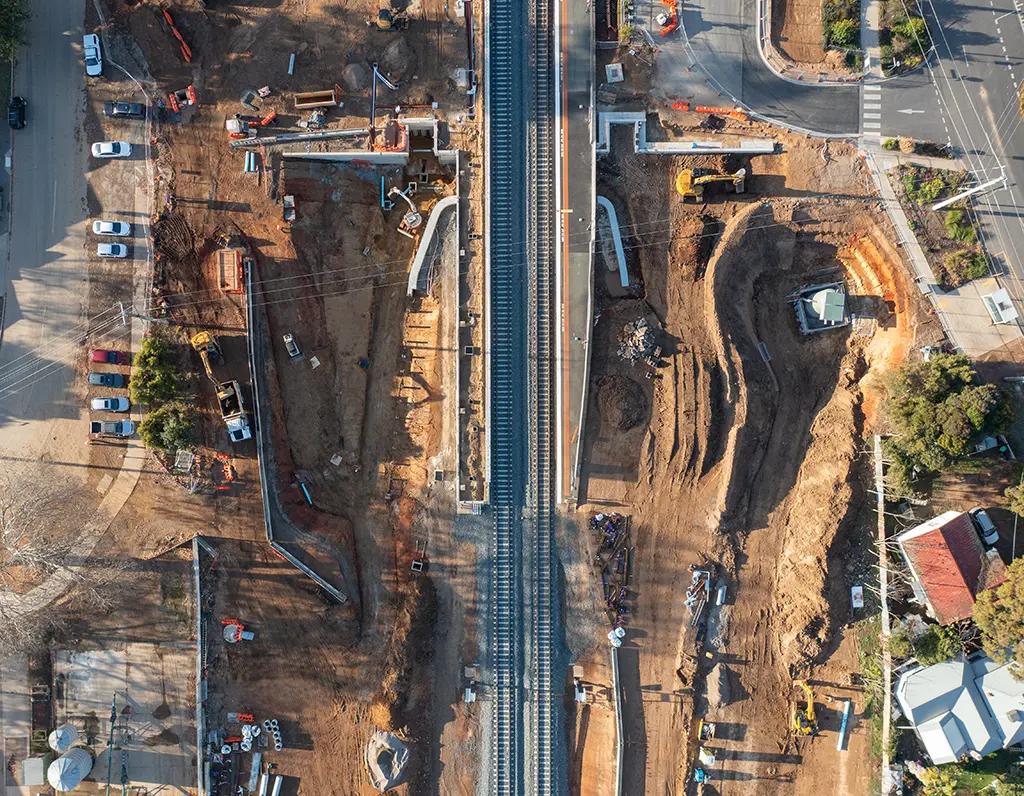 An aerial view of train tracks in the middle of a construction site.