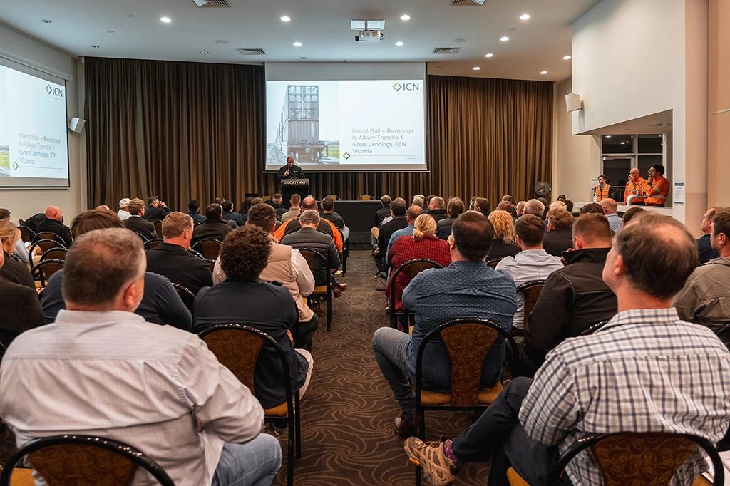 People sitting in a room listening to a lecture.