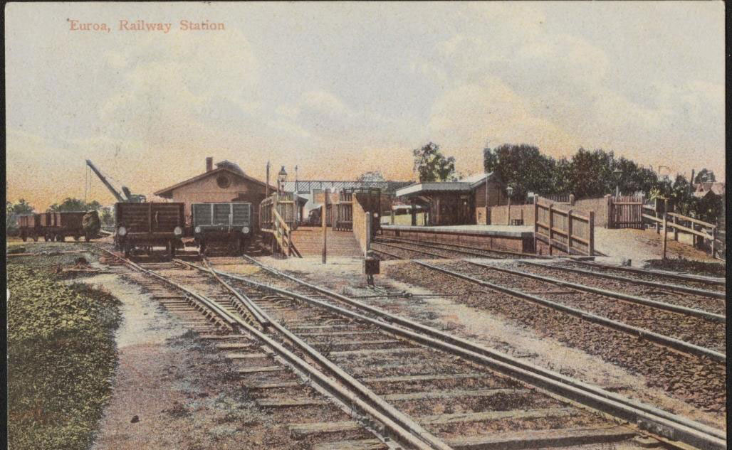 A train yard as captured in 1906. A range of buildings around a train track, with the phrase 'Euroa Railway Station' written on the image.