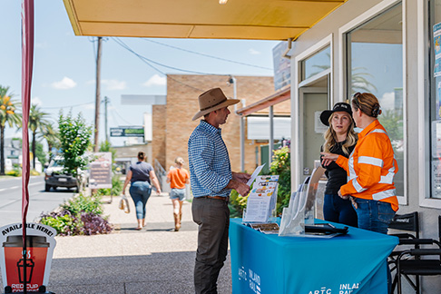 Image of three Inland Rail stakeholder engagement team members standing outside an office, in front of a table