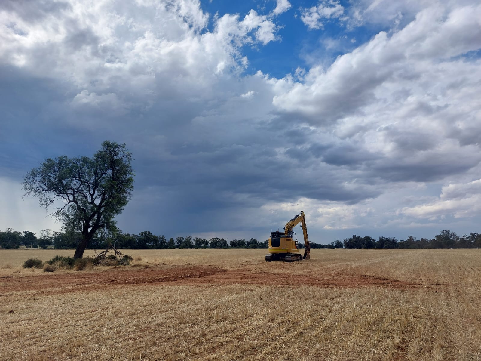 An excavator ready to dig a test pit as part of geotechnical investigations