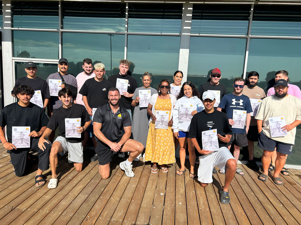 A group of people holding certificates.