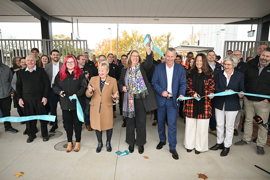 Group of people cutting a ribbon