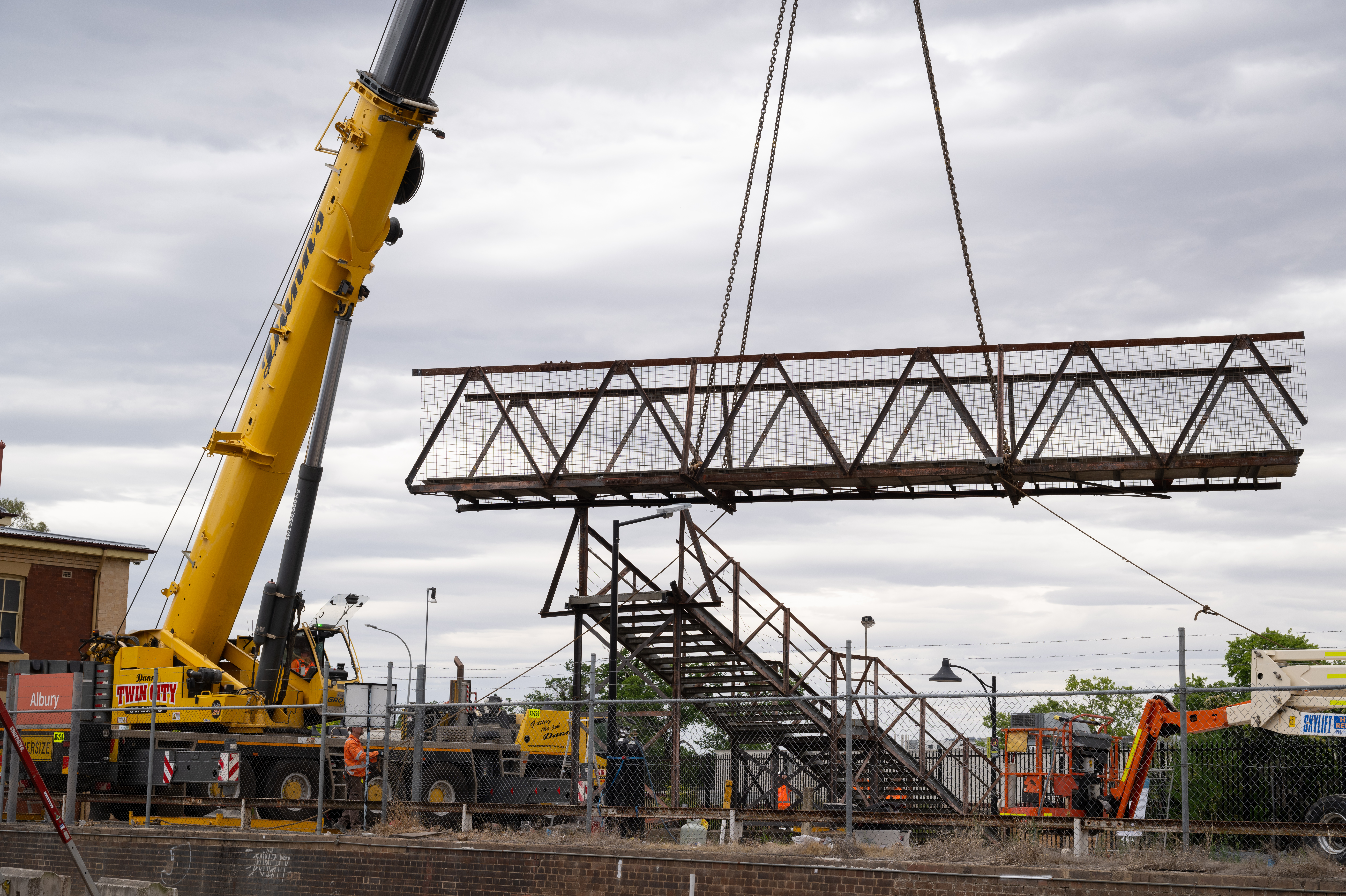 Crane removing footbridge at Albury Station as a part of Inland Rail works