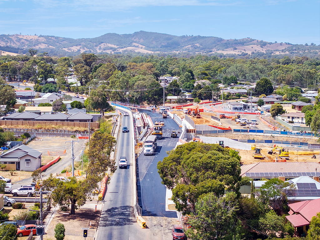 Aerial view of roadworks and construction activity along a suburban street.