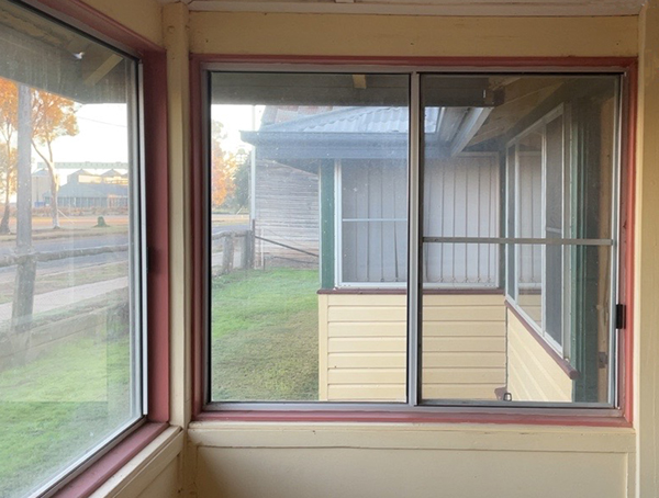 A window looking out to a rural setting.