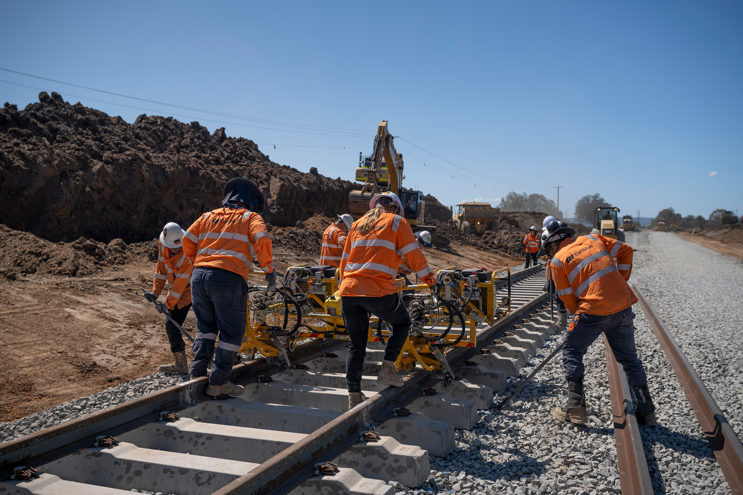 People in high visibility safety fear work on a railway line.