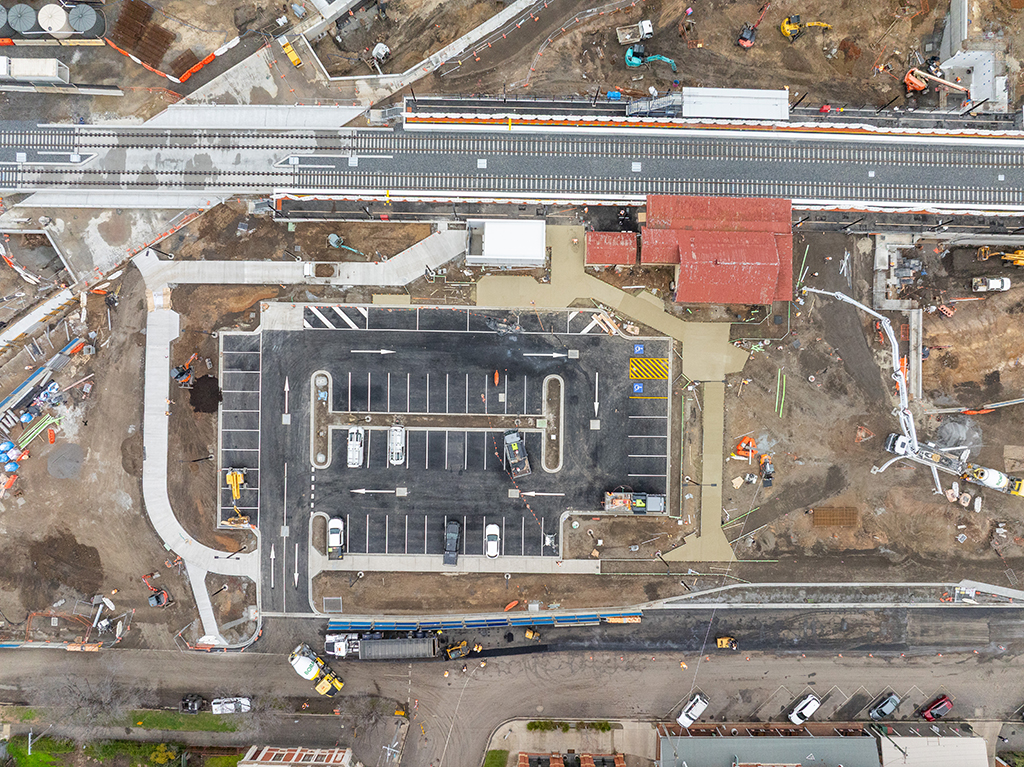 Top-down aerial view of the new station car park, pedestrian paths and railway tracks at Euroa Station.